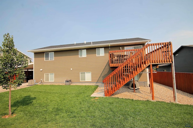 back of house featuring central AC unit, fence, stairs, a deck, and a lawn