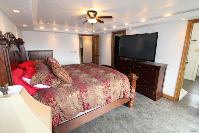 bedroom featuring baseboards, light colored carpet, recessed lighting, a textured ceiling, and a raised ceiling