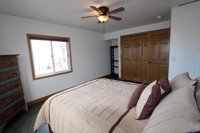 bedroom with carpet flooring, baseboards, a closet, and ceiling fan