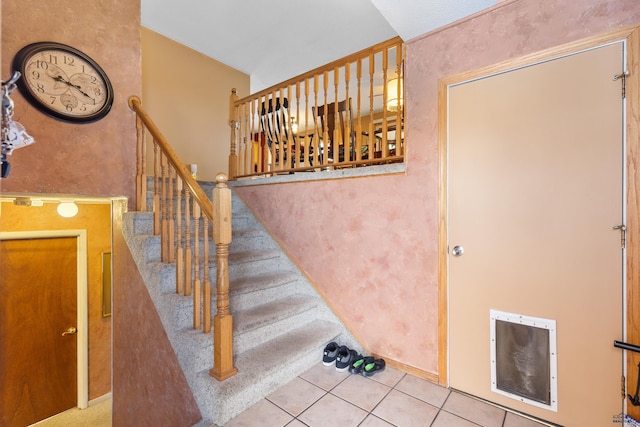 stairs featuring tile patterned floors