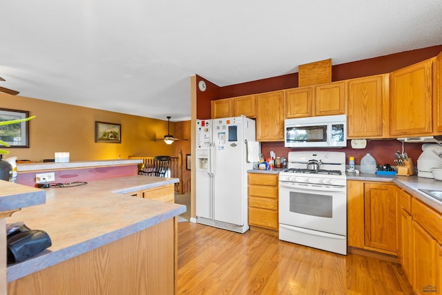 kitchen with white appliances, light countertops, and ceiling fan