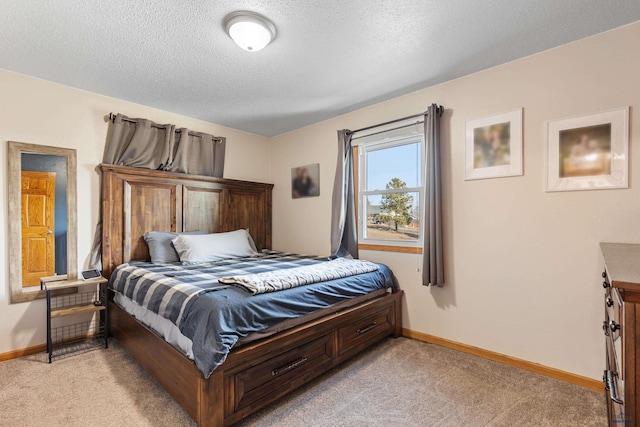 bedroom featuring baseboards, light colored carpet, and a textured ceiling