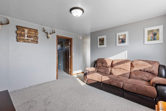 living area featuring visible vents and carpet flooring