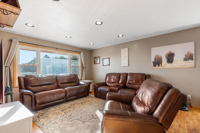 living room with recessed lighting and light wood-style flooring