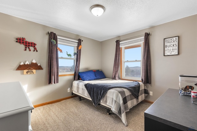 bedroom with baseboards, multiple windows, and light colored carpet