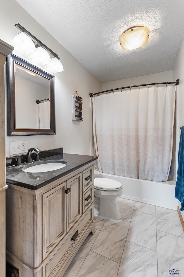 bathroom with toilet, vanity, shower / tub combo with curtain, marble finish floor, and a textured ceiling