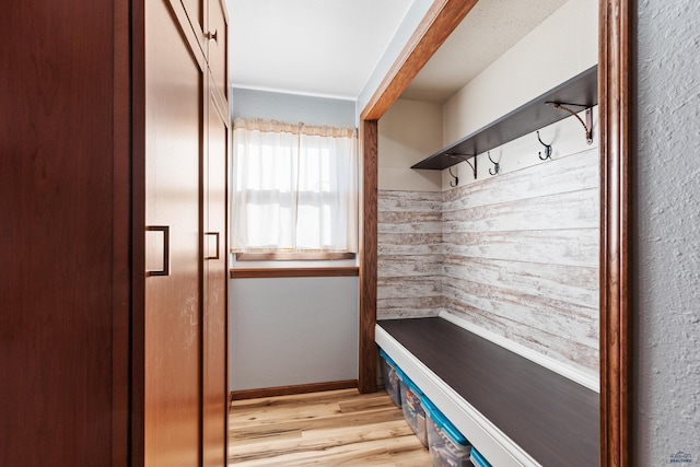 mudroom with baseboards and light wood-style floors