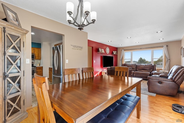 dining area featuring an inviting chandelier, recessed lighting, and light wood finished floors