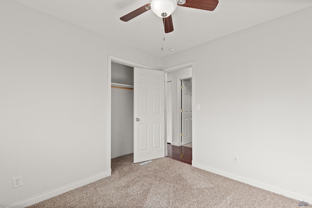 unfurnished bedroom featuring a closet, carpet flooring, ceiling fan, and baseboards