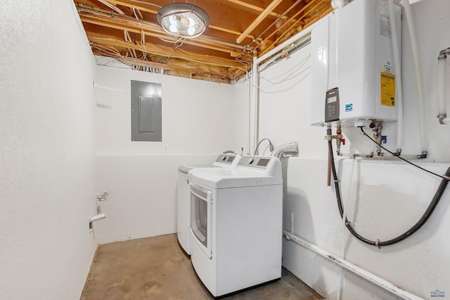 laundry room featuring electric panel, laundry area, water heater, and washing machine and clothes dryer