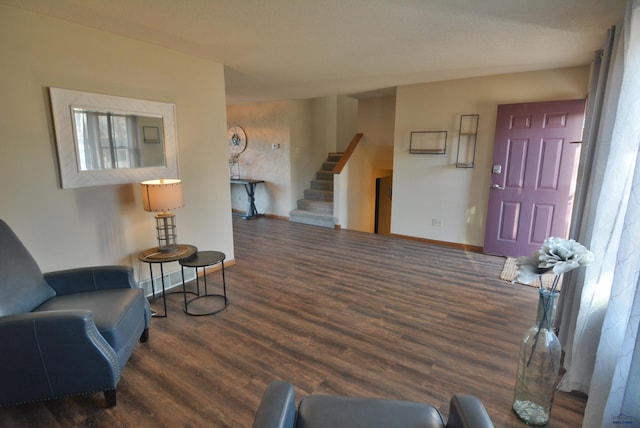 foyer entrance with stairway, wood finished floors, and baseboards