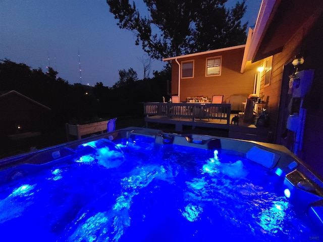 pool at night with a deck