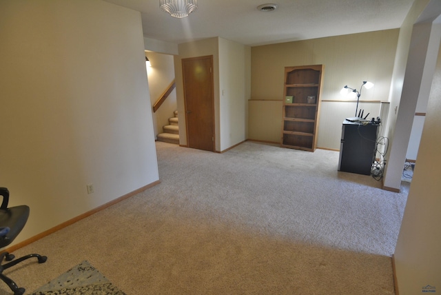 interior space with stairway, baseboards, visible vents, and carpet floors