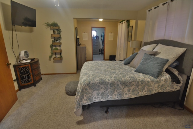 bedroom featuring carpet flooring and baseboards