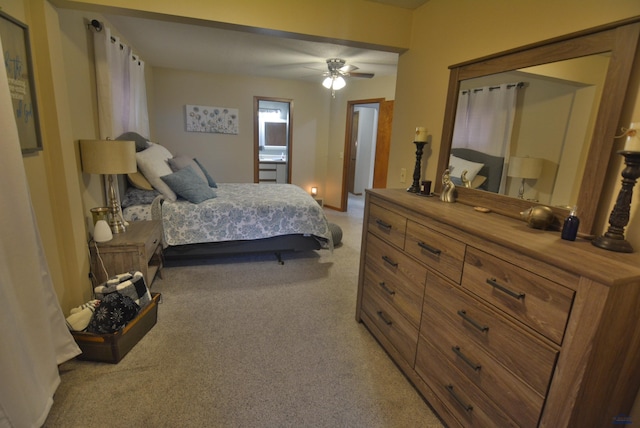 bedroom featuring light carpet and a ceiling fan