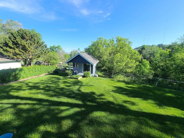 view of yard with an outdoor structure and fence