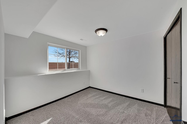 unfurnished bedroom with visible vents, baseboards, and carpet