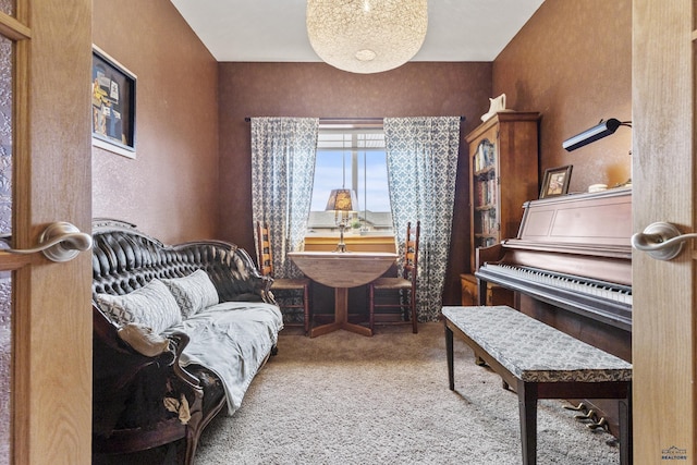 sitting room featuring carpet and a textured wall