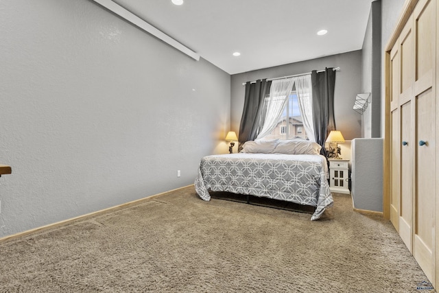 bedroom featuring recessed lighting, carpet floors, and a textured wall