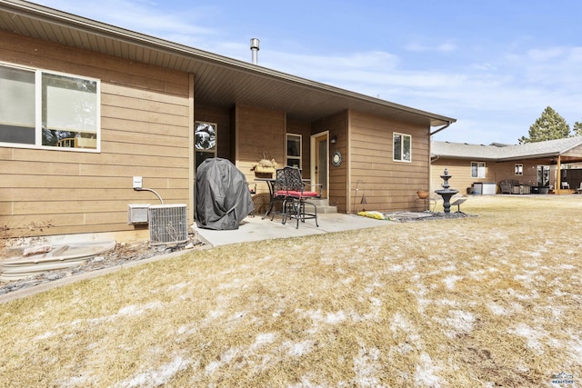 back of house with cooling unit and a patio