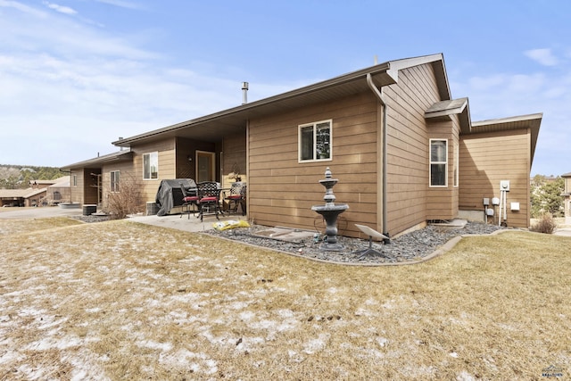 rear view of property featuring a patio area