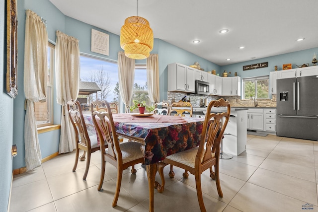 dining space featuring light tile patterned flooring, recessed lighting, and baseboards