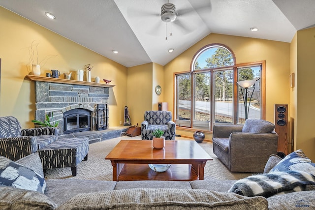 carpeted living area featuring a stone fireplace, recessed lighting, a ceiling fan, and lofted ceiling