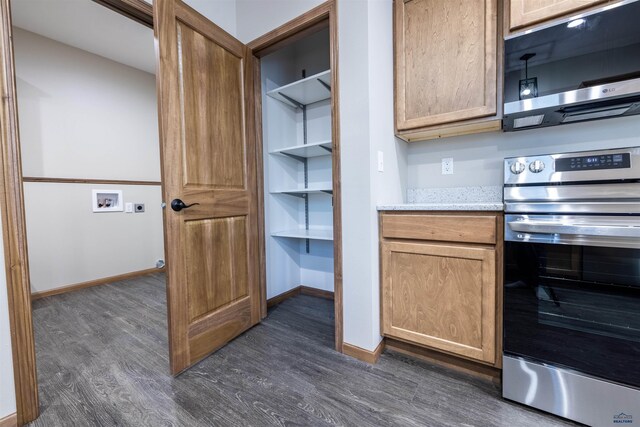 kitchen featuring light stone counters, baseboards, stainless steel electric range, and dark wood-style flooring