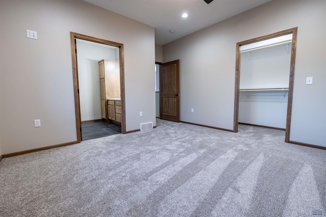 unfurnished bedroom with baseboards, visible vents, carpet floors, recessed lighting, and a closet