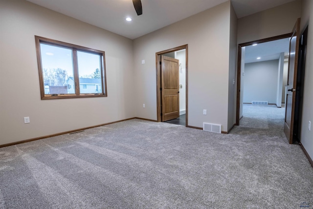 unfurnished bedroom featuring recessed lighting, carpet, and visible vents