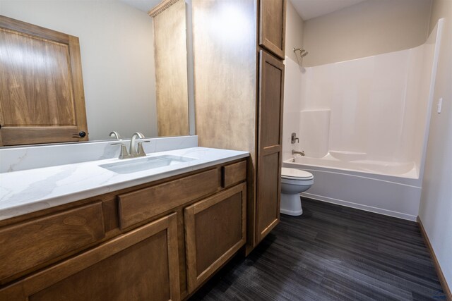 full bath featuring shower / bathtub combination, toilet, vanity, and wood finished floors