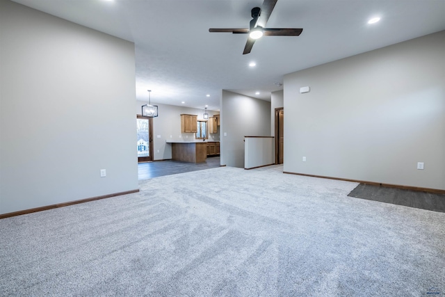 unfurnished living room with recessed lighting, light colored carpet, baseboards, and ceiling fan