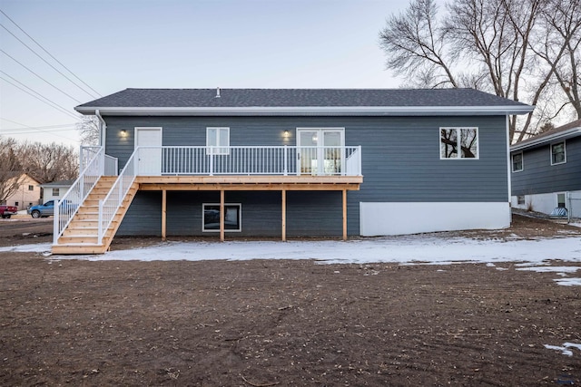 rear view of property with stairway and a deck