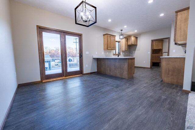 kitchen featuring baseboards, a peninsula, recessed lighting, dark wood-type flooring, and light countertops