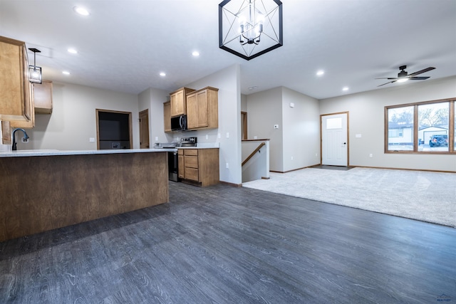 kitchen with dark wood-type flooring, recessed lighting, open floor plan, and stainless steel appliances