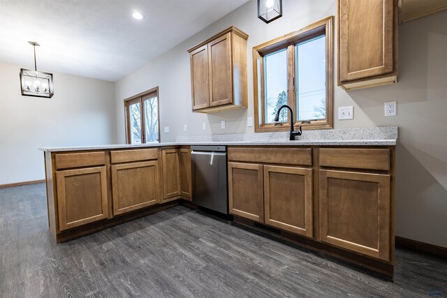 kitchen featuring brown cabinetry, stainless steel dishwasher, a peninsula, and dark wood-style flooring