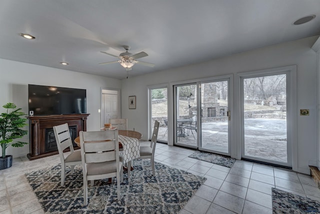 dining room featuring light tile patterned floors, recessed lighting, ceiling fan, and a fireplace