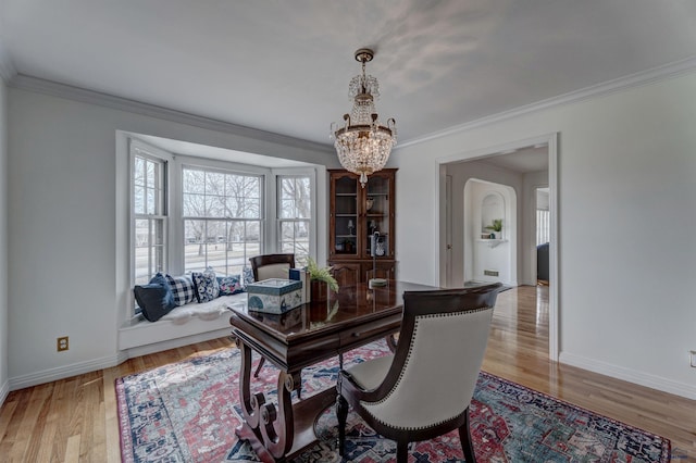 office with a notable chandelier, baseboards, light wood-style floors, and crown molding