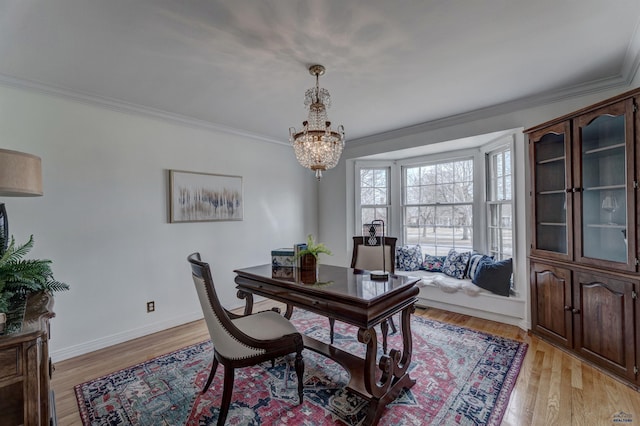 office space with light wood finished floors, a chandelier, crown molding, and baseboards