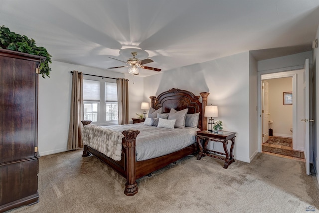 bedroom with light carpet, ceiling fan, and baseboards