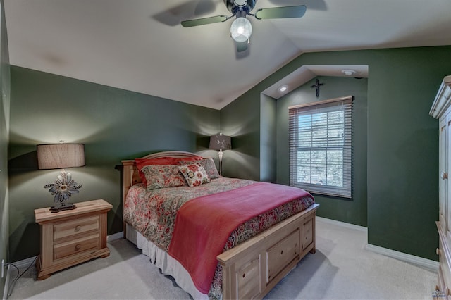 bedroom featuring baseboards, lofted ceiling, light colored carpet, and a ceiling fan