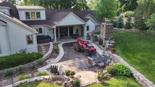 back of house featuring a patio area, a lawn, a chimney, and roof with shingles