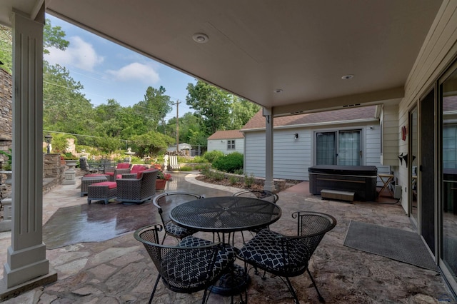 view of patio featuring a hot tub and outdoor dining area