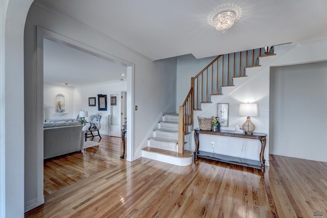 entrance foyer with stairs, wood finished floors, and baseboards