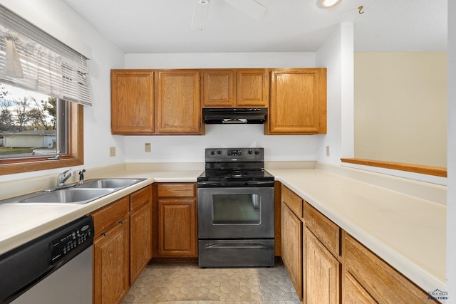 kitchen with a sink, light countertops, under cabinet range hood, range with electric stovetop, and stainless steel dishwasher