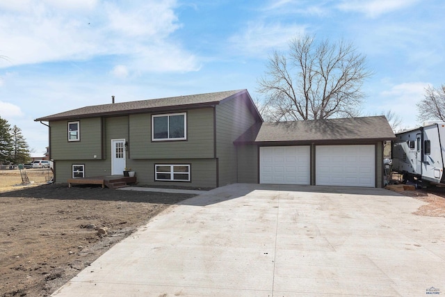 bi-level home with driveway and a garage