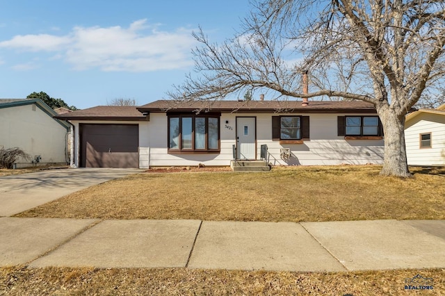 single story home with a garage, concrete driveway, and a front lawn