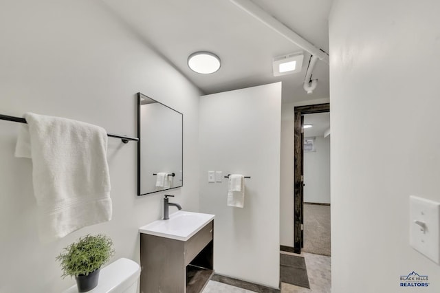 bathroom featuring toilet and vanity