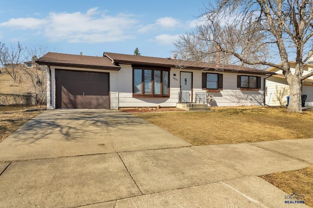 single story home with a garage, concrete driveway, and a shingled roof