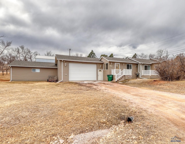 ranch-style home with driveway and an attached garage